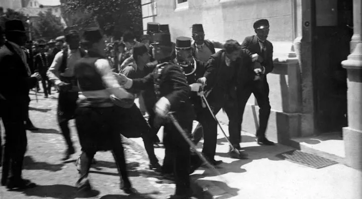 A man is arrested shortly after Franz Ferdinand's assassination by a crowd of men