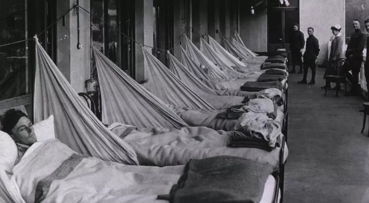 A WWI hospital has most of its beds full