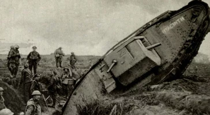 A British WWI tank climbs its way out of a trench