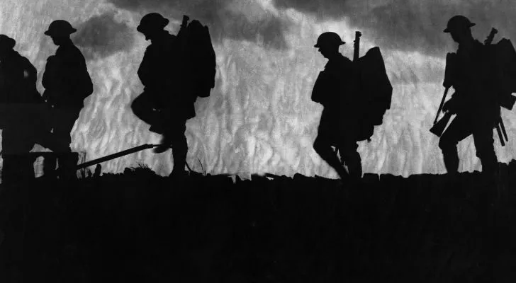 The silhouettes of British soldiers walking