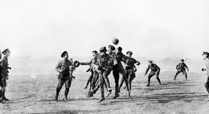 A group of soldiers play football during a truce in WWI