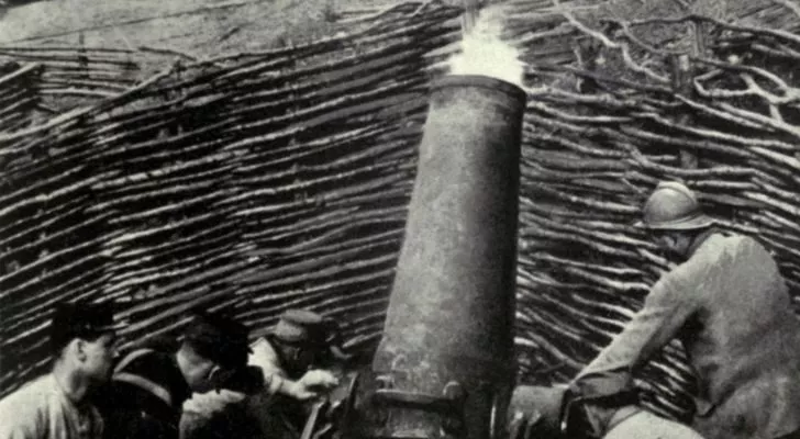 A large piece of WWI artillery firing a shell