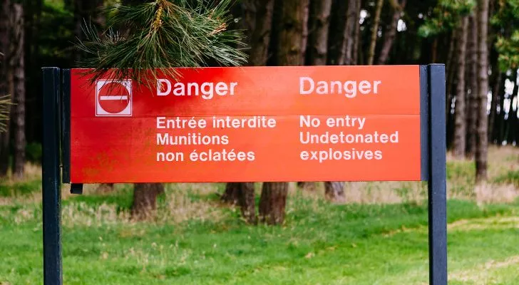 A modern sign warning of unexploded munitions in the area