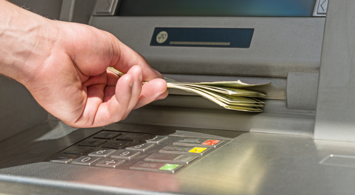 Ръка на човек, който вади пари от банкомат